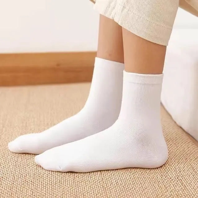 Black, white, and grey boat socks and medium tube socks from Degner in cotton blend fabric