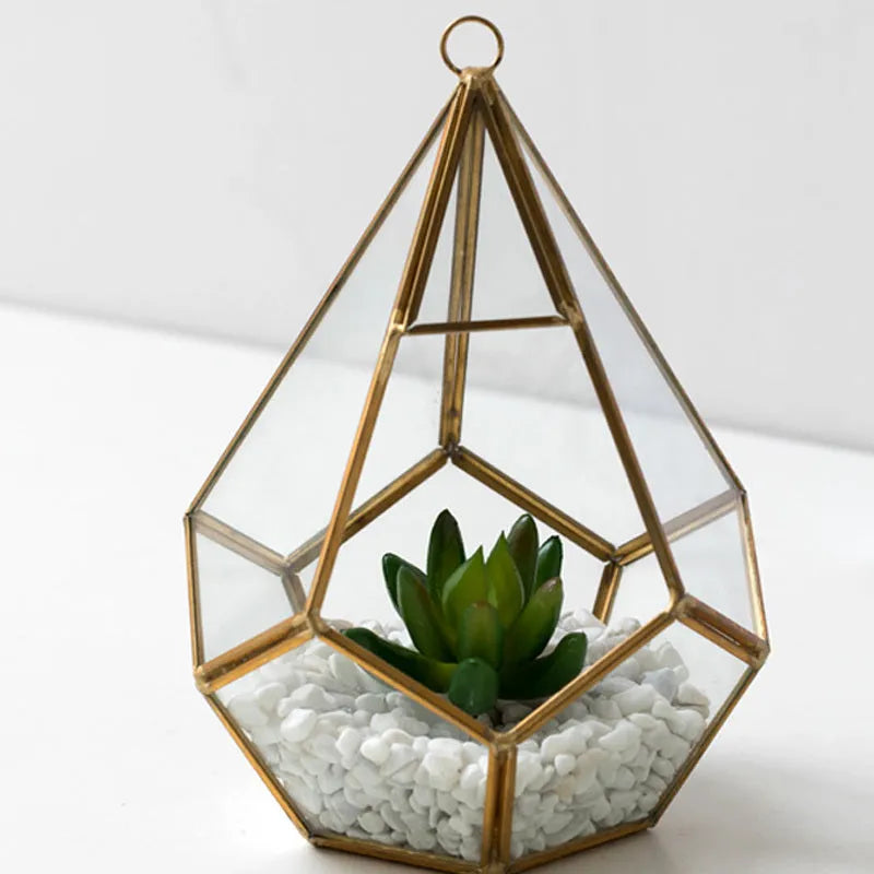 Metal and glass succulent decoration in Golden Love style on a living room table