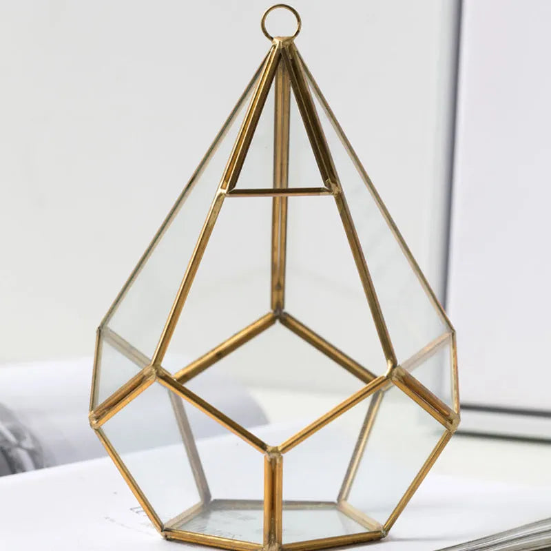 Metal and glass succulent decoration in Golden Love style on a living room table