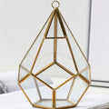 Metal and glass succulent decoration in Golden Love style on a living room table