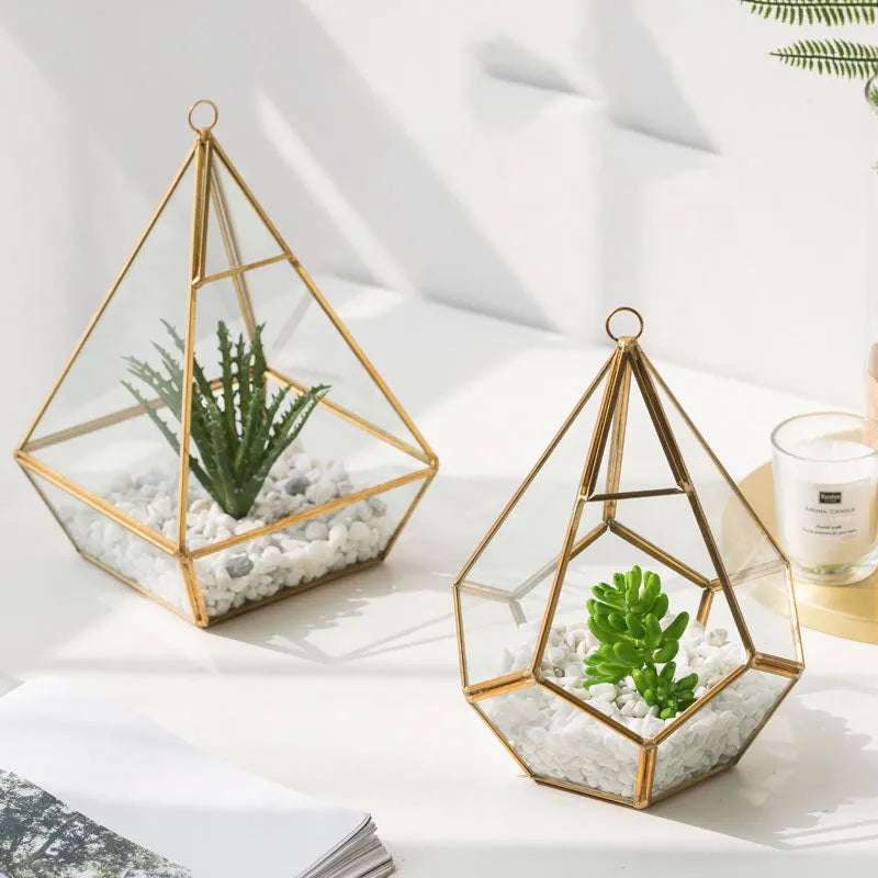 Metal and glass succulent decoration in Golden Love style on a living room table