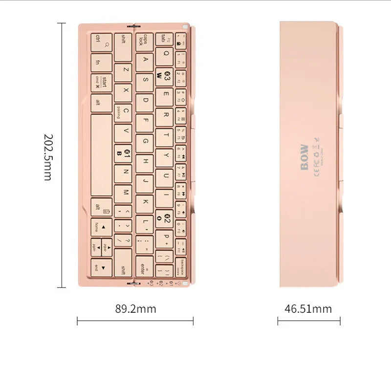 Silver white mini folding Bluetooth keyboard open next to a smartphone on its integrated stand.