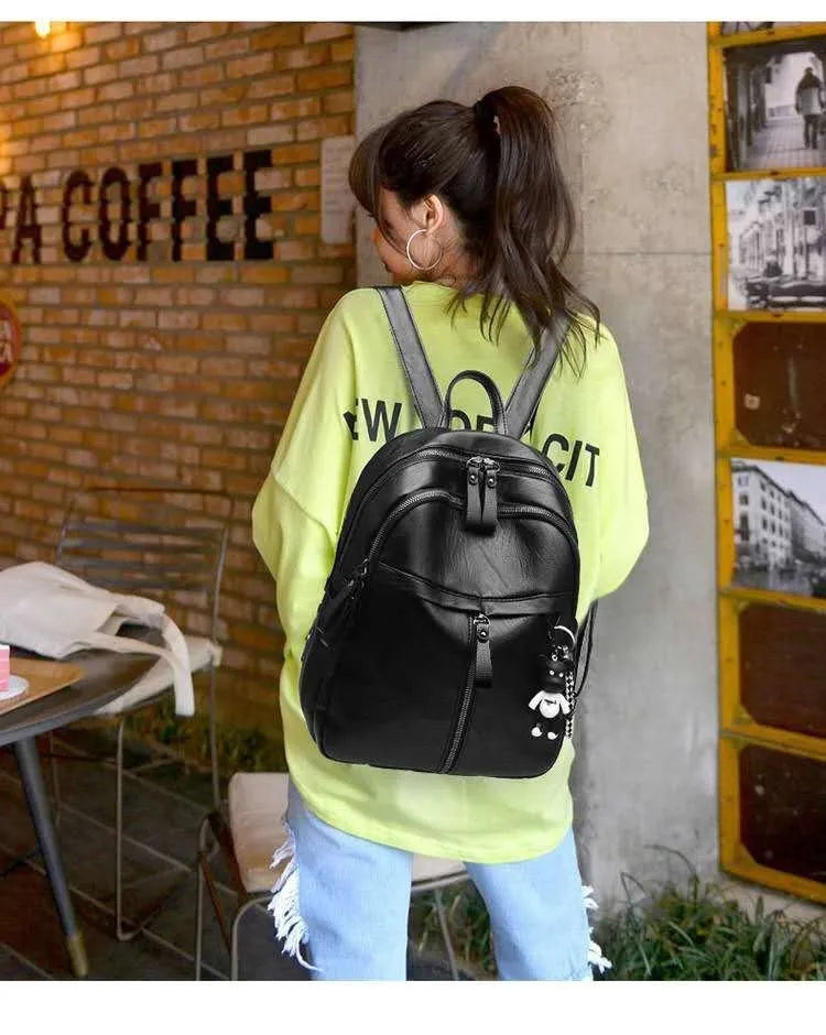 Black PU leather soft surface backpack with double straps showing 20-35L capacity and plain design