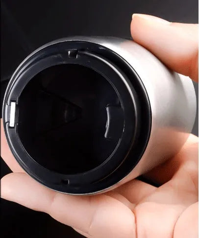 Stainless steel automatic beer bottle opener with press mechanism and magnetic cap catcher on a table