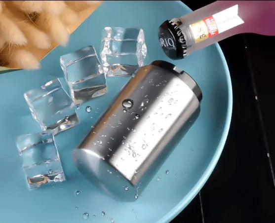 Stainless steel automatic beer bottle opener with press mechanism and magnetic cap catcher on a table