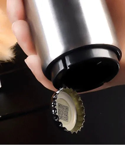 Stainless steel automatic beer bottle opener with press mechanism and magnetic cap catcher on a table