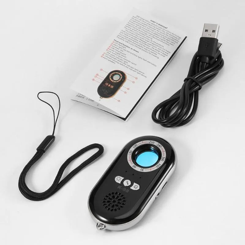 Compact black wireless vibration alarm detector for travel security placed on a door