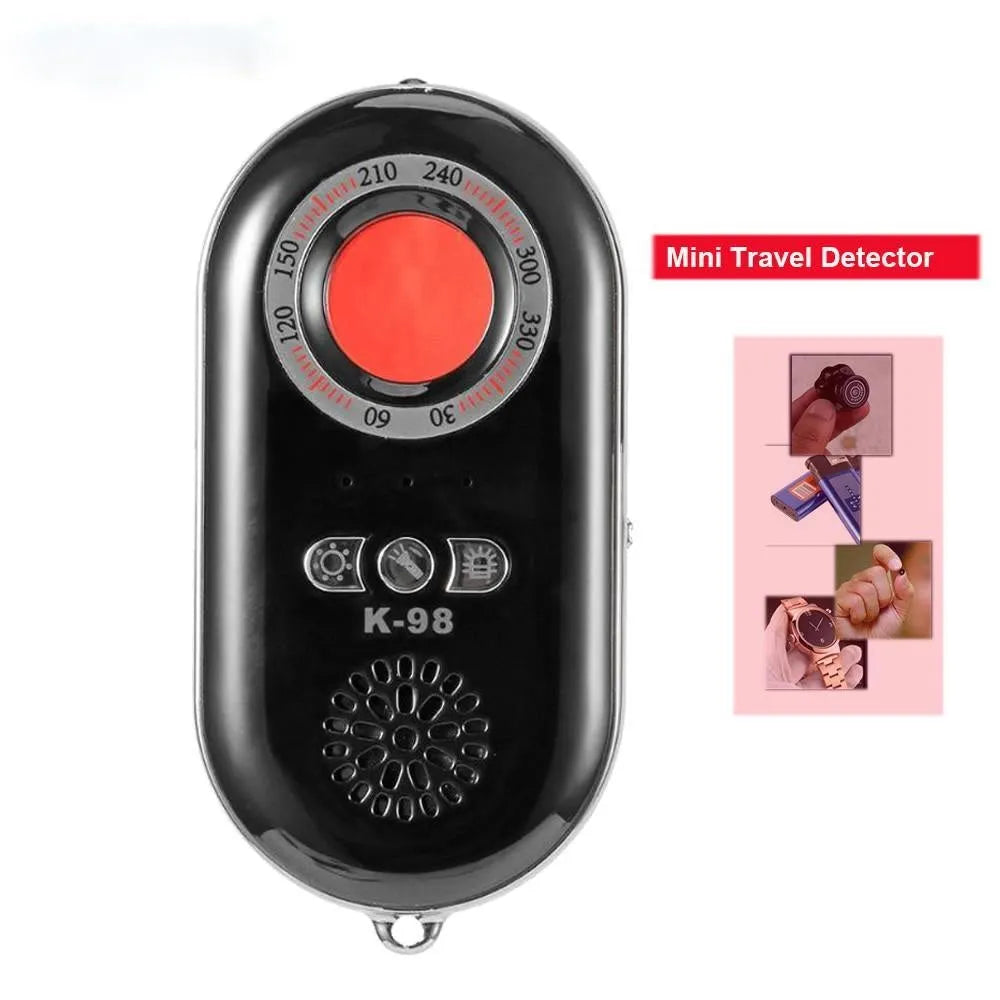 Compact black wireless vibration alarm detector for travel security placed on a door