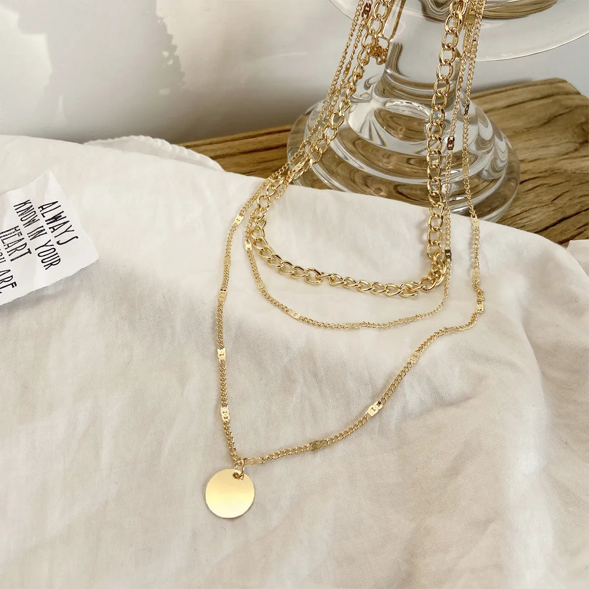 Women's multilayer disc pendant necklace in gold alloy electroplated finish on clavicle-length chain