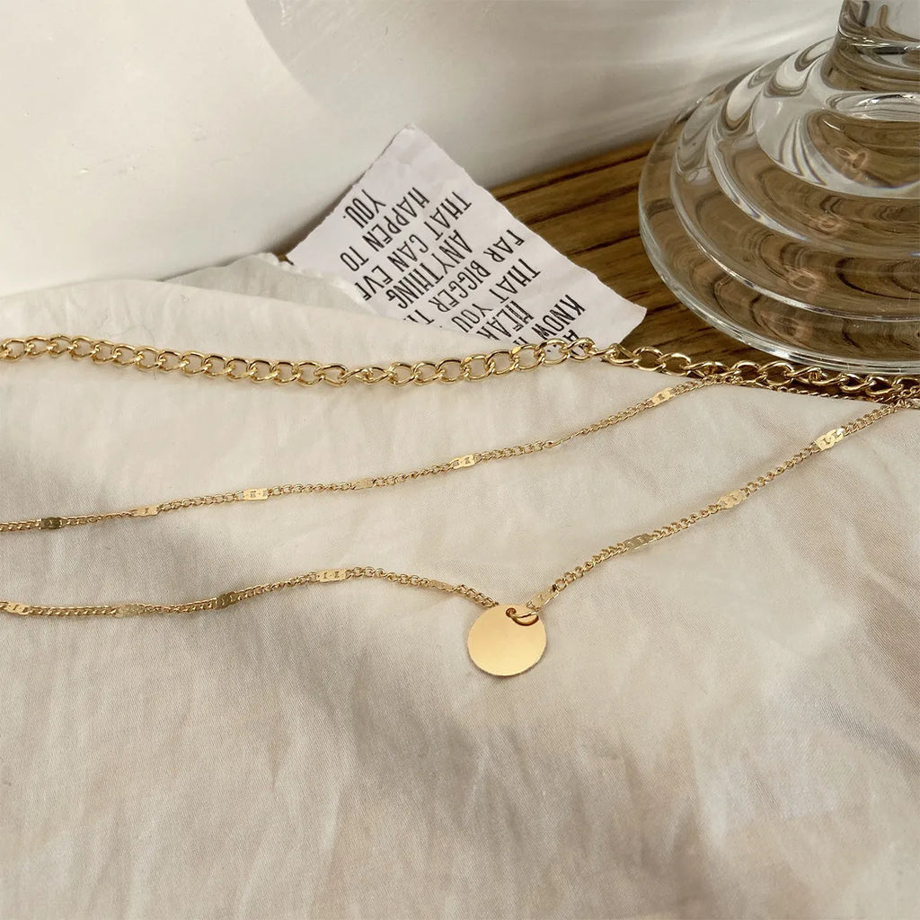 Women's multilayer disc pendant necklace in gold alloy electroplated finish on clavicle-length chain