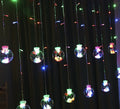 2.5 metre 108 LED curtain light string in warm white mode on a dark background showing plastic shell and plug-in cable