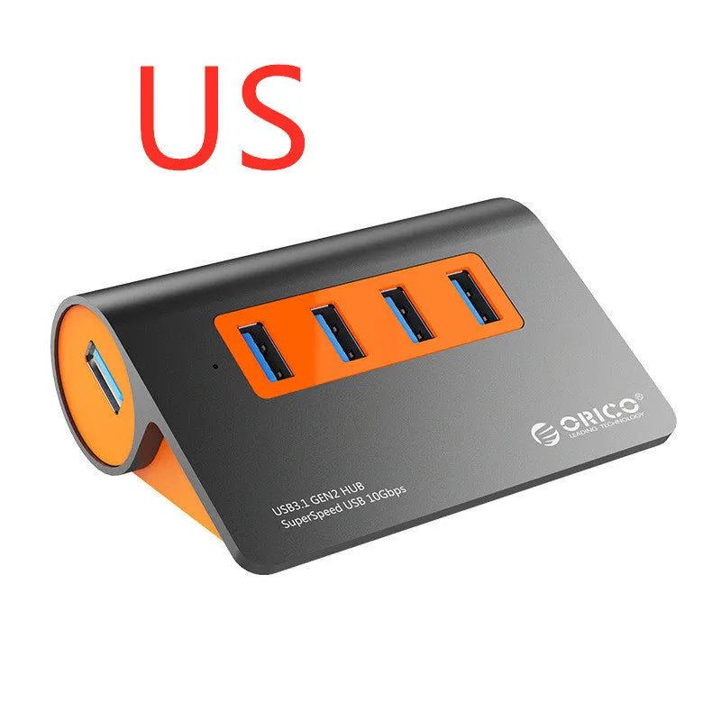 Dark grey aluminium USB hub with four USB 3.1 ports, orange accent, and detachable 100cm cable