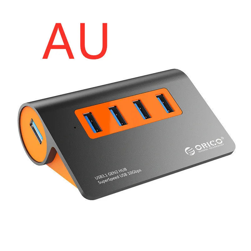Dark grey aluminium USB hub with four USB 3.1 ports, orange accent, and detachable 100cm cable
