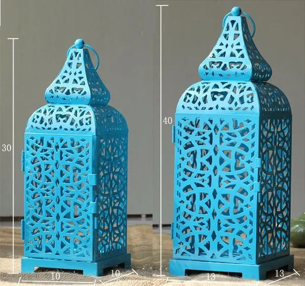 Pair of blue geometric iron Moroccan candlesticks with hollow design for tealights.