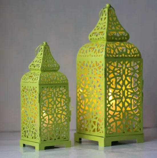 Pair of blue geometric iron Moroccan candlesticks with hollow design for tealights.