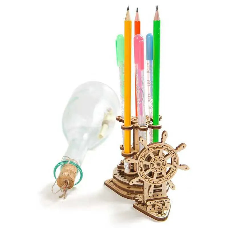 Wooden rotating pen holder model with a steering wheel mechanism on a desk.