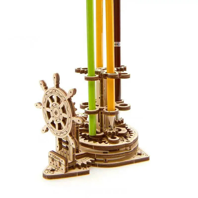 Wooden rotating pen holder model with a steering wheel mechanism on a desk.