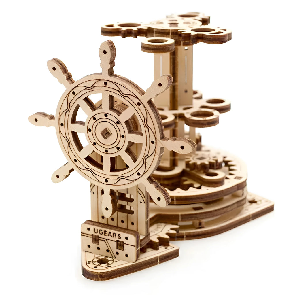 Wooden rotating pen holder model with a steering wheel mechanism on a desk.