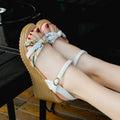 Women's pink wedge sandals with thick heel and buckle closure on white background