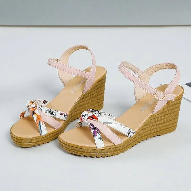 Women's pink wedge sandals with thick heel and buckle closure on white background
