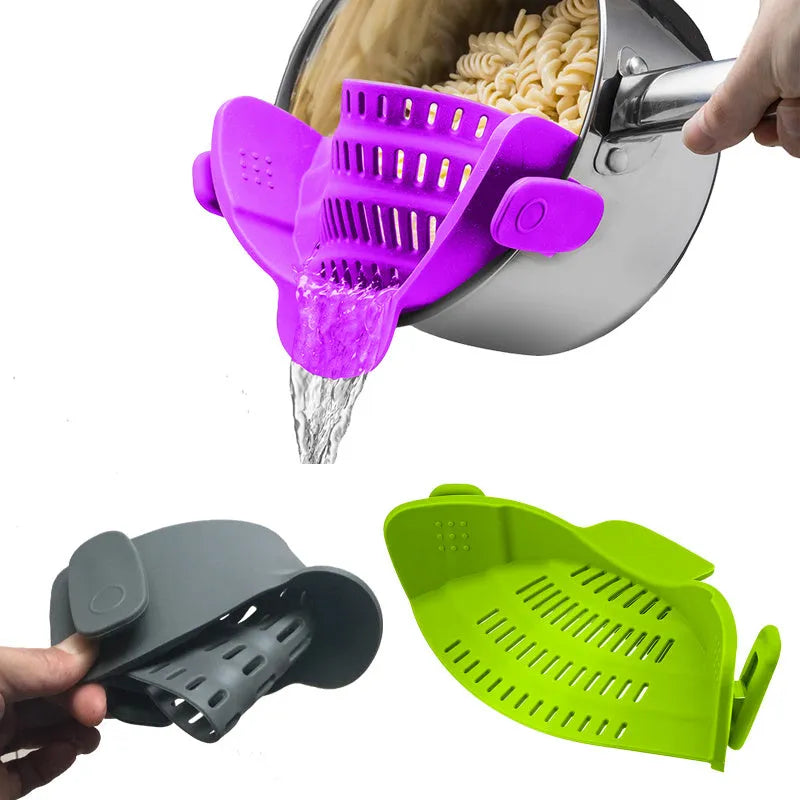 Silicone clip-on pot strainer with uniform hollow design in Red, attached to a stainless steel pot rim