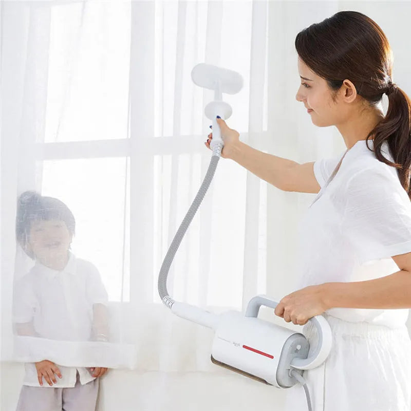 Deerma DEM-ZQ610 multi function steam cleaner with white body, five brush heads, and glass scraper on a light background