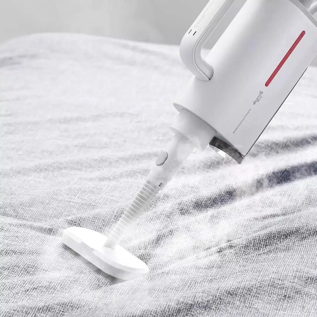 Deerma DEM-ZQ610 multi function steam cleaner with white body, five brush heads, and glass scraper on a light background