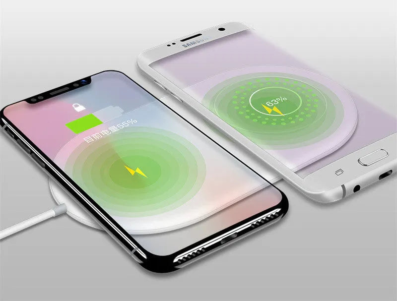 White dual wireless charger for mobile phones showing two devices charging simultaneously