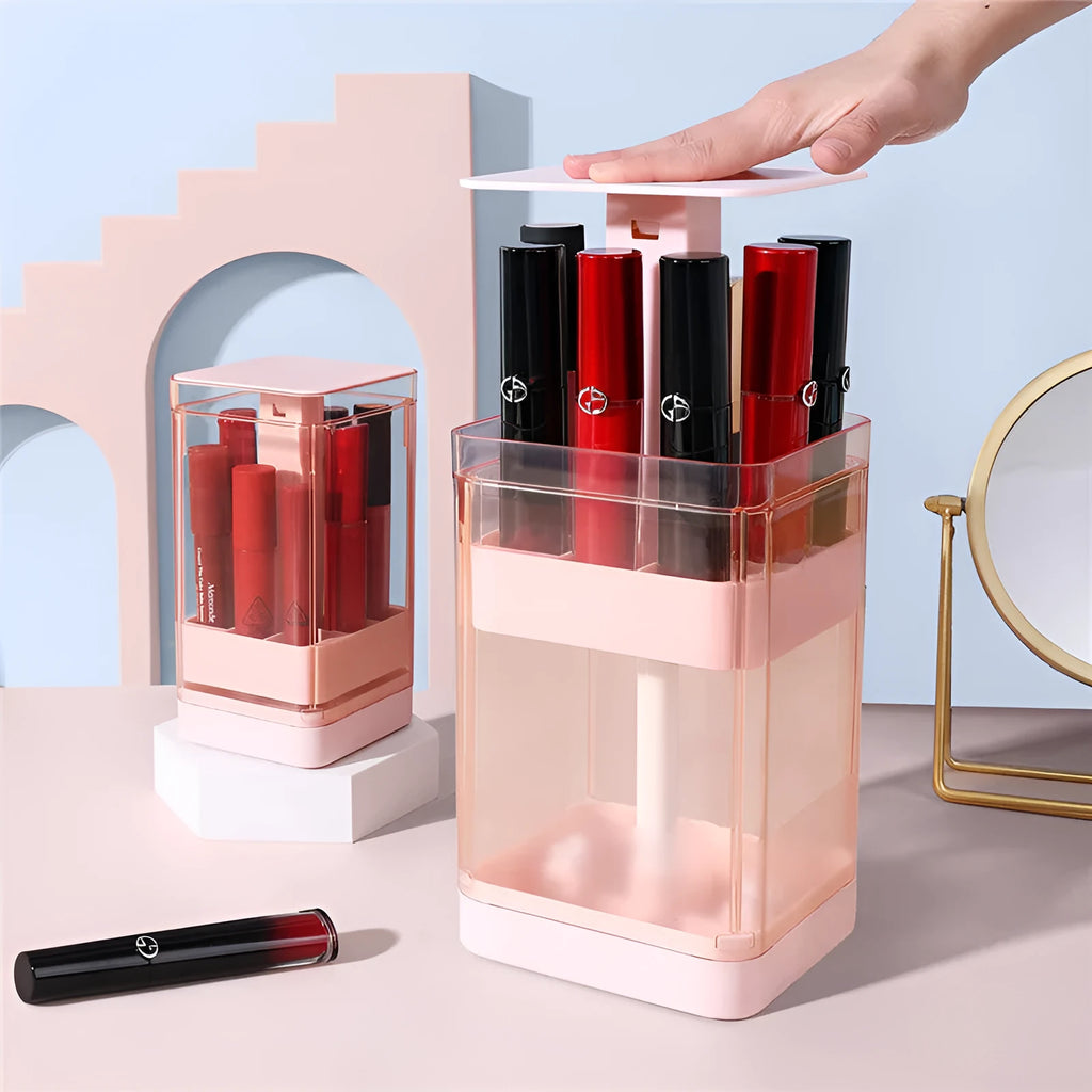 Pink press lift lipstick storage box with dust-proof belt cover on a desktop.