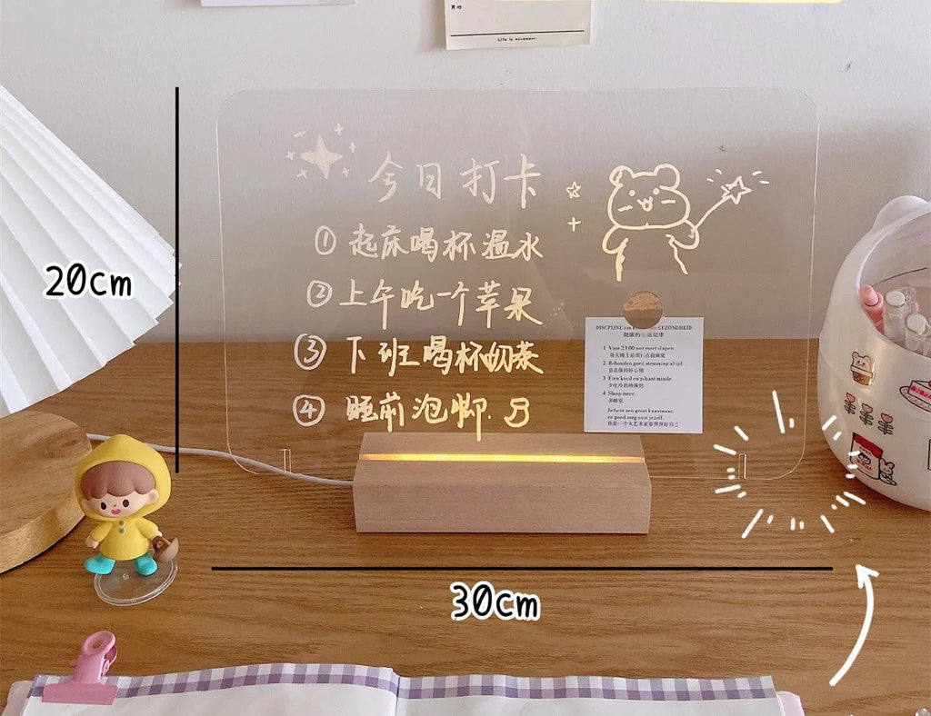 LED bedside lamp with erasable message board available in seven design options including candle simulation and bear shapes