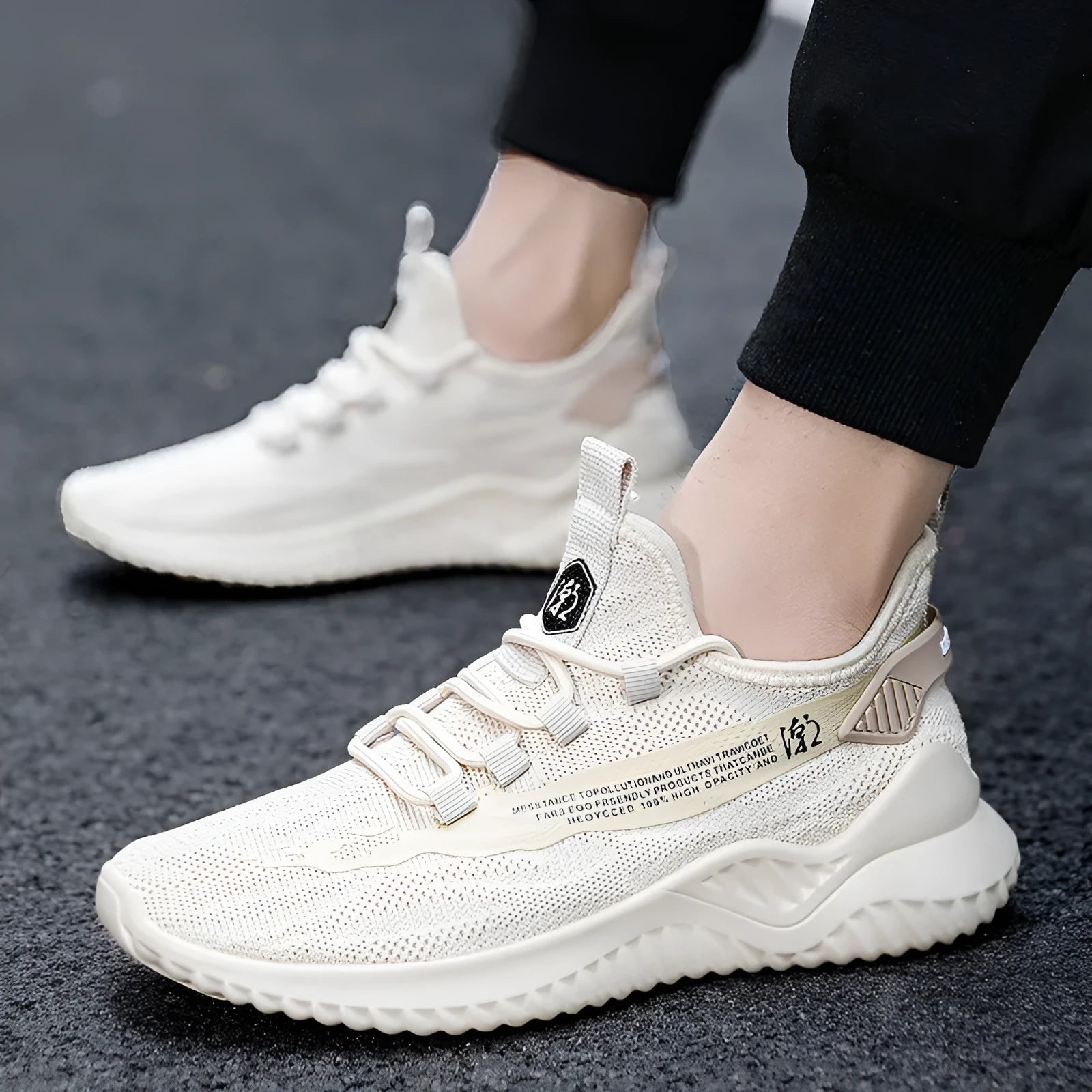 Men's white low-top mesh sports shoes with rubber sole and front tie laces on a plain background