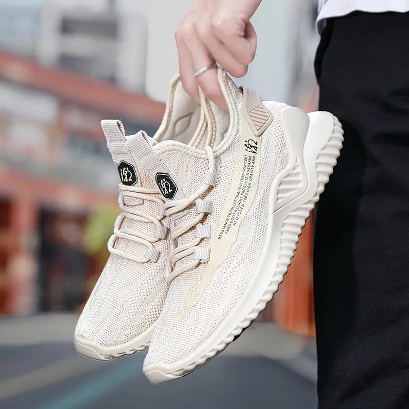 Men's white low-top mesh sports shoes with rubber sole and front tie laces on a plain background