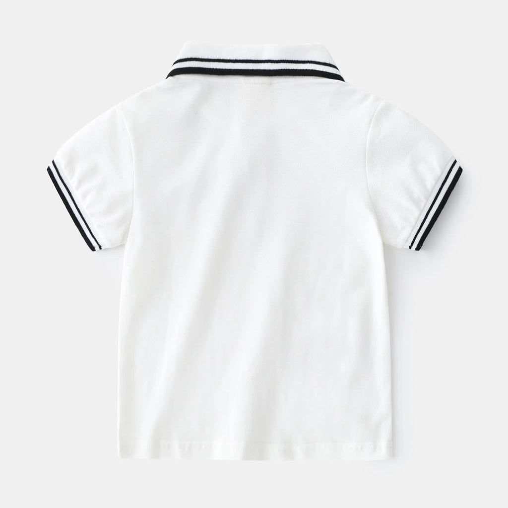 White boys cotton polo shirt with short sleeves and a round neck on a flat lay.