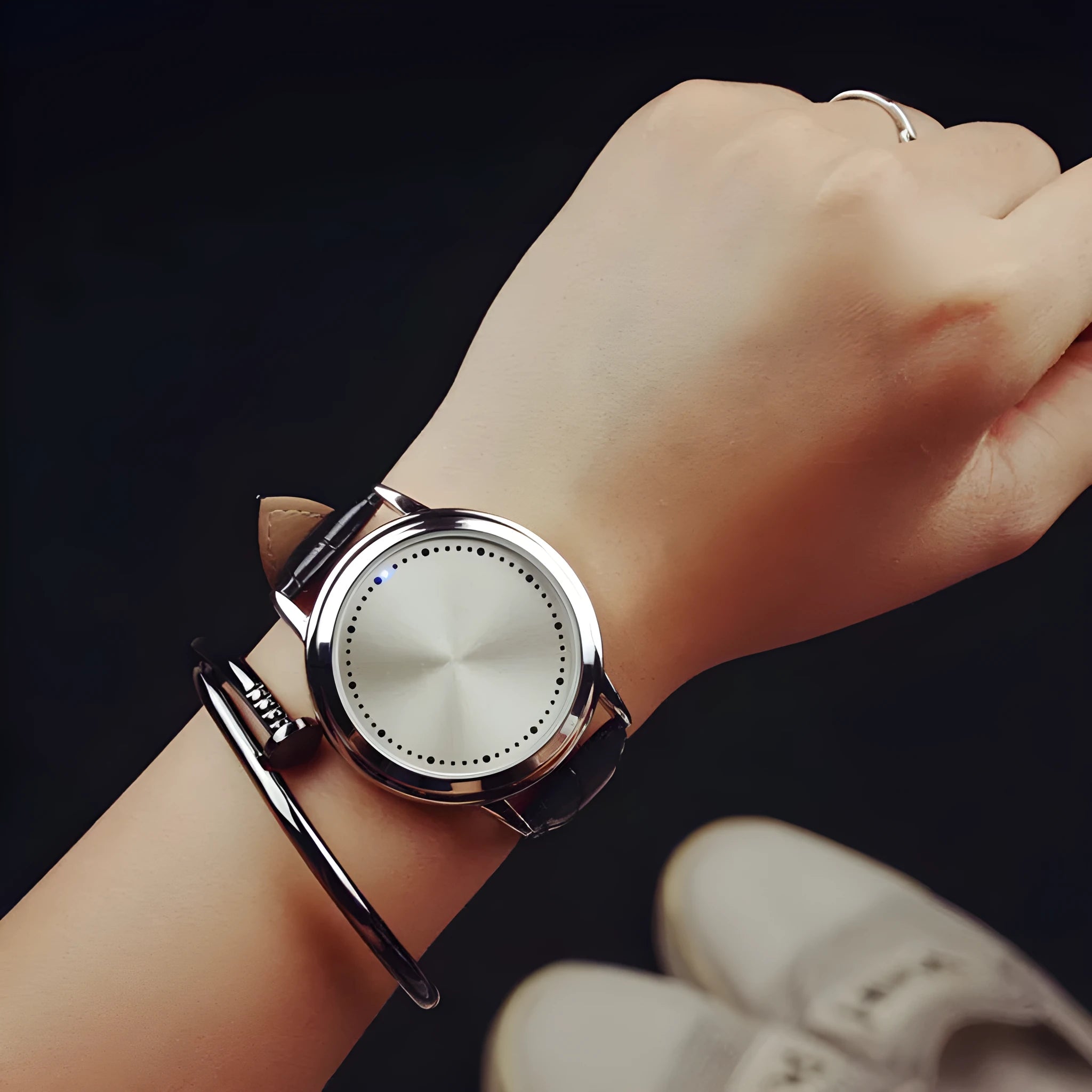 Electronic digital watch with blue LED display and plastic case on wrist