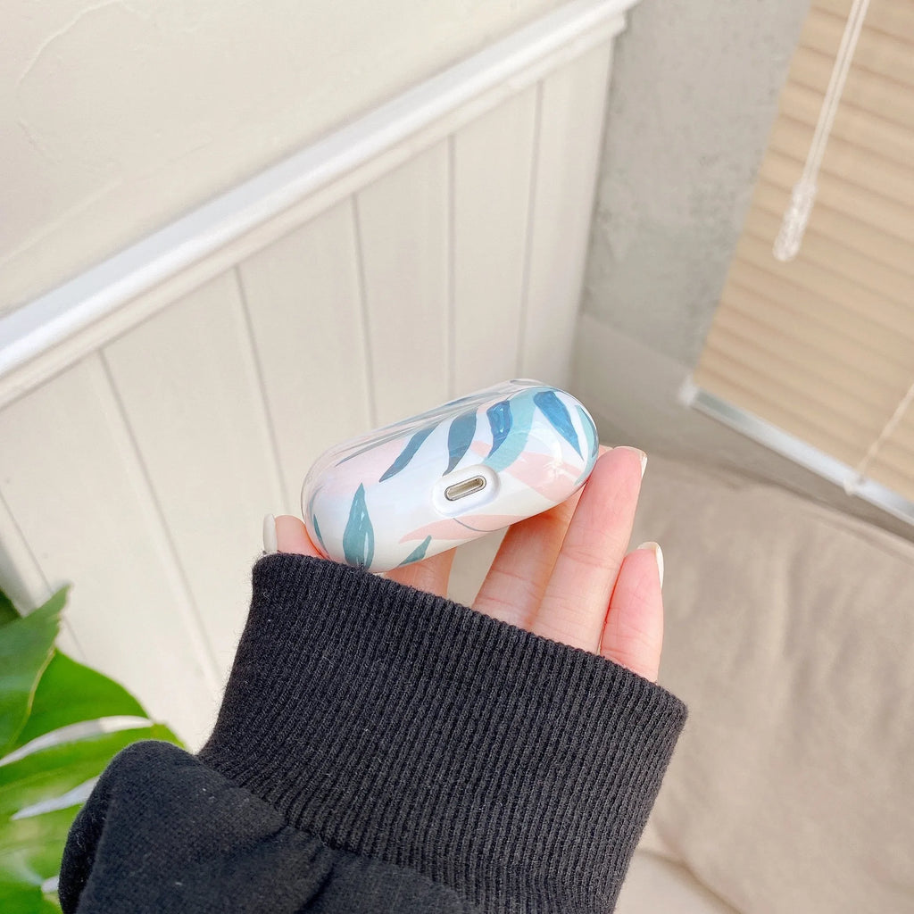 Blue and green banana leaves design soft TPU protective case for Apple AirPods charging case.