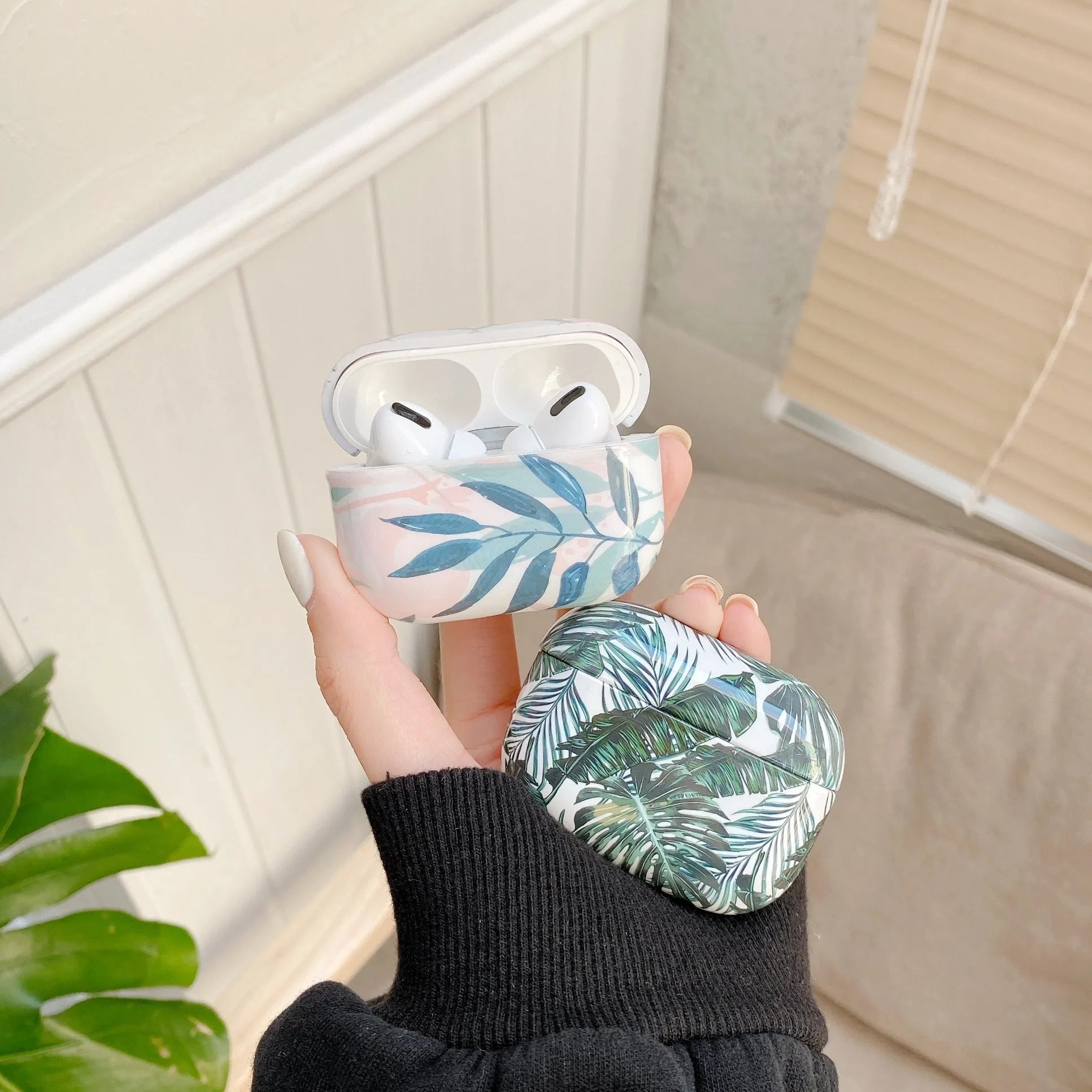 Blue and green banana leaves design soft TPU protective case for Apple AirPods charging case.