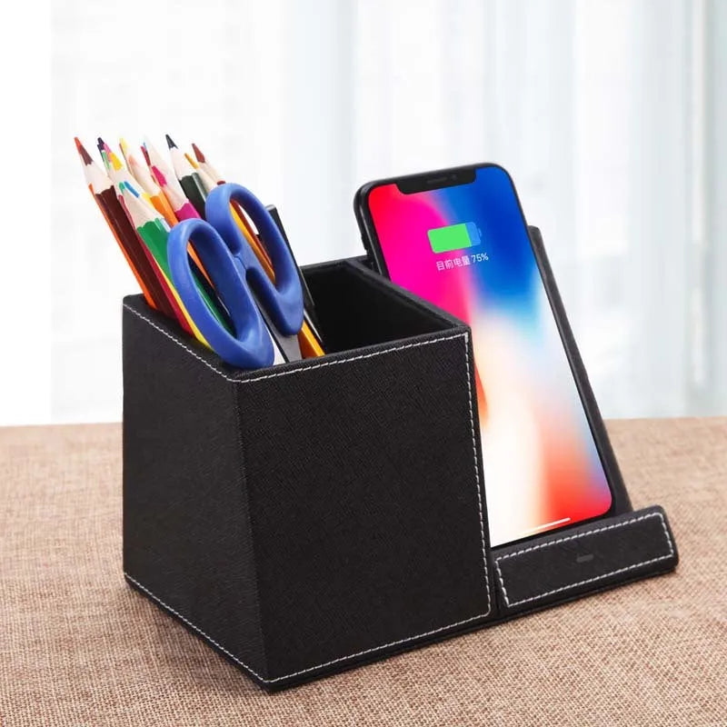 Leather pen holder wireless charger on desk with phone charging and pens organised