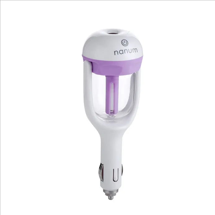 Compact blue car humidifier diffuser with rotating nozzle on a car dashboard