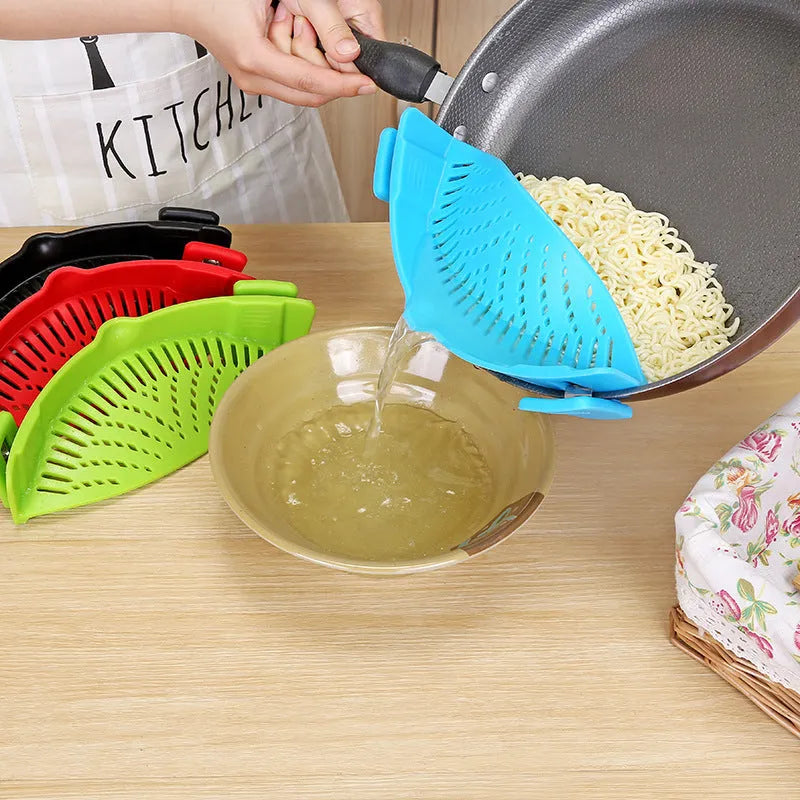 Silicone clip-on pot strainer with uniform hollow design in Red, attached to a stainless steel pot rim
