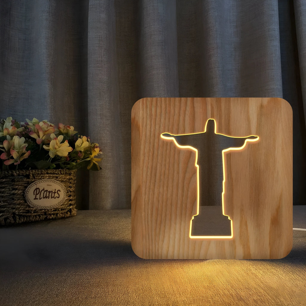 Solid wood hollow night lamp with warm white LED light, USB cable, and button switch on a wooden table