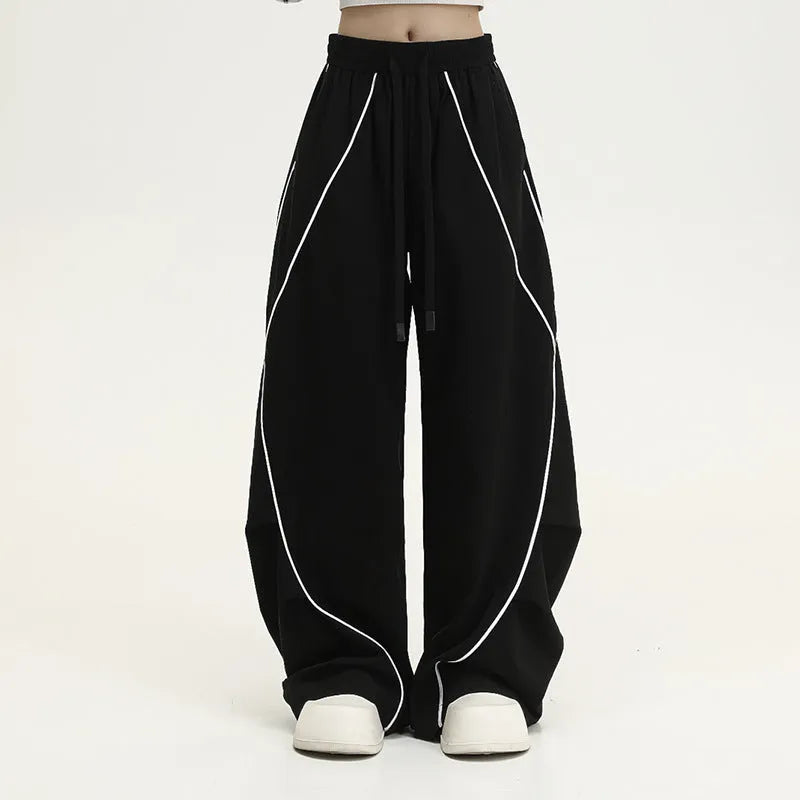 Black pleated wide-leg sports trousers with vertical stripe pattern and mid waist