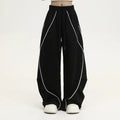 Black pleated wide-leg sports trousers with vertical stripe pattern and mid waist