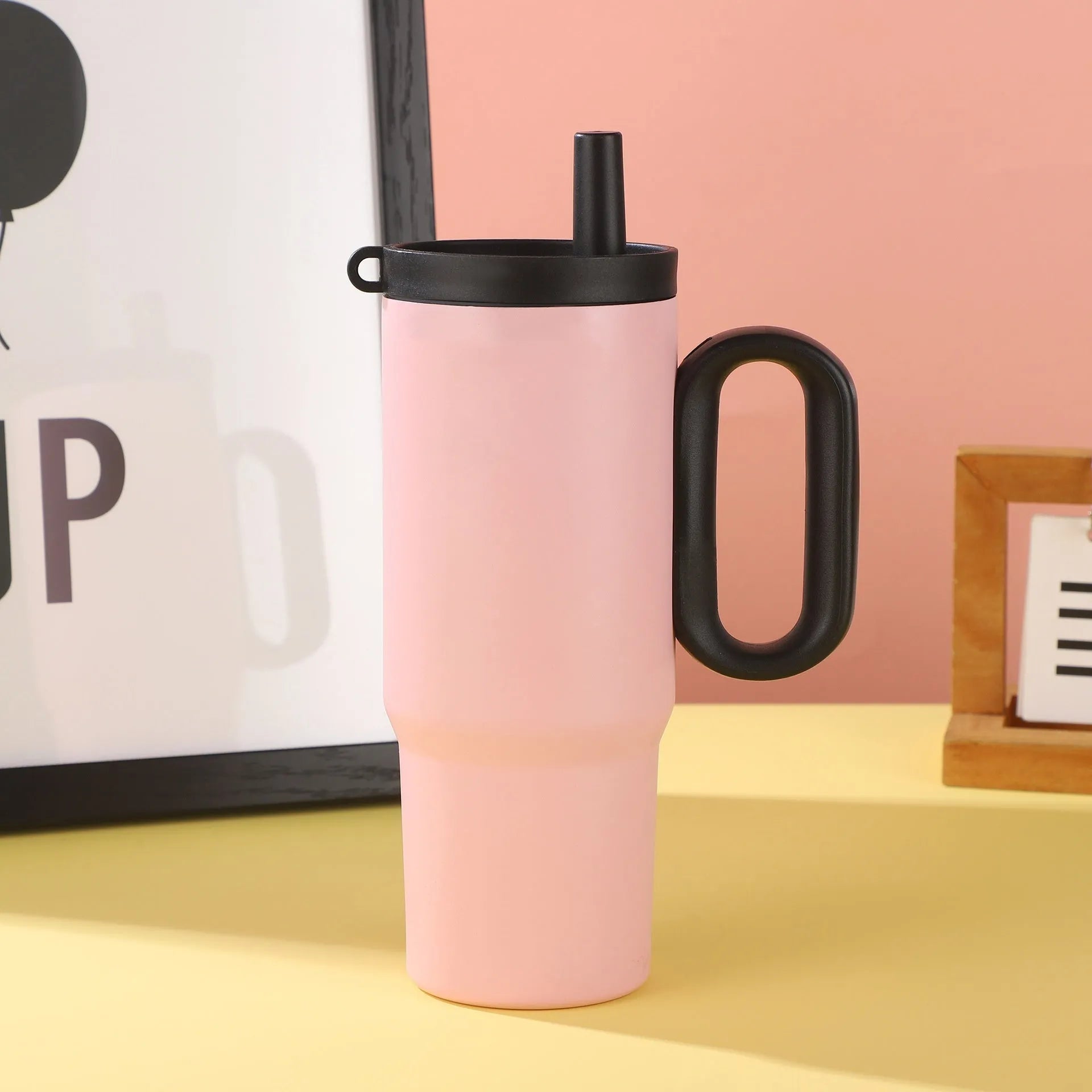 Portable insulated drink cup with carry handle and straw lid in multiple colours