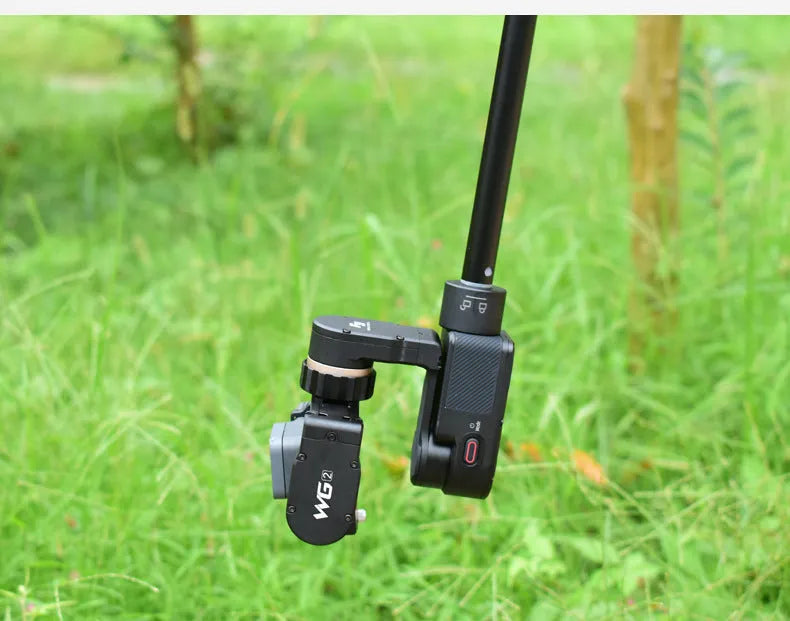 Black retractable aluminium selfie stick extended with phone attached and Bluetooth remote