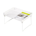 Plastic kitchen supplies rack in transparent colour on a countertop holding spice jars and small bottles