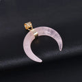 Close-up of a pink natural stone moon pendant necklace on a copper chain, showing textural detail.