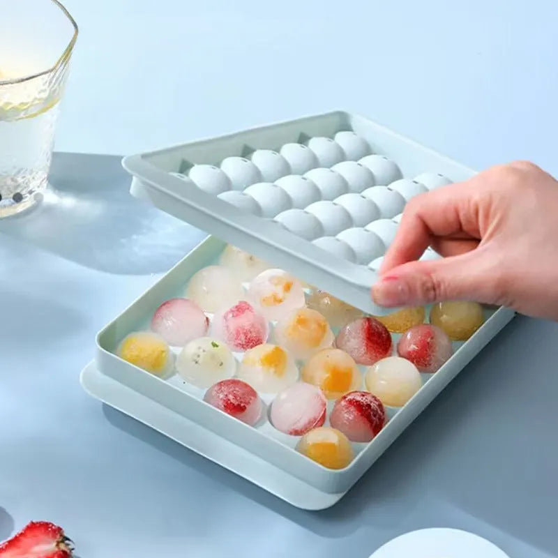 Blue silicone round ice cube tray with lid showing 33 grid design