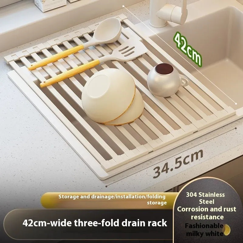 Milky white foldable stainless steel kitchen draining rack placed next to a sink.
