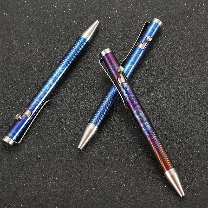 Titanium alloy gun bolt handle ball pen with magic colour phantom finish on a desk.