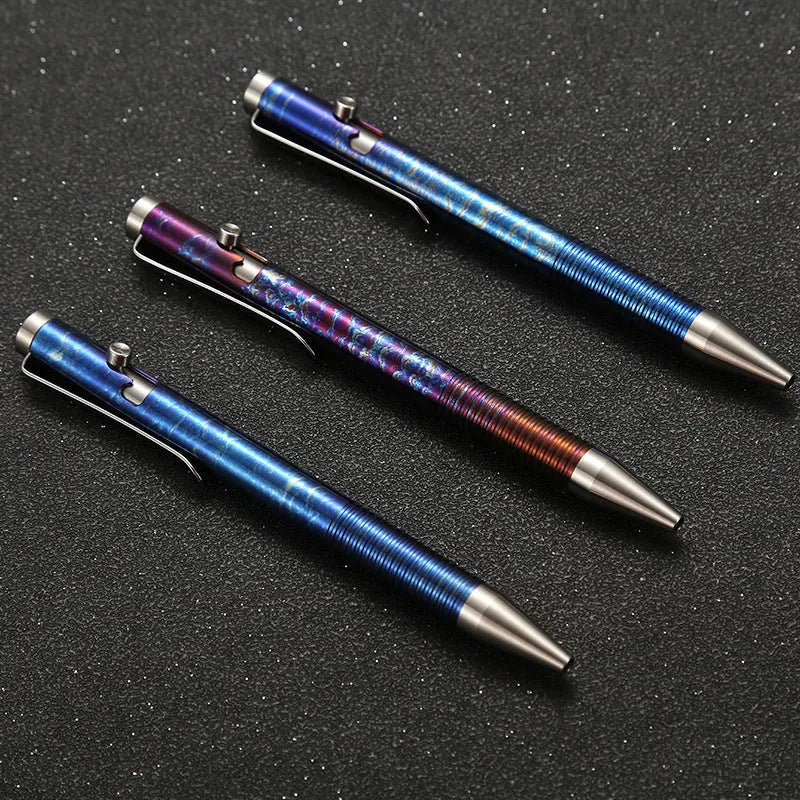 Titanium alloy gun bolt handle ball pen with magic colour phantom finish on a desk.